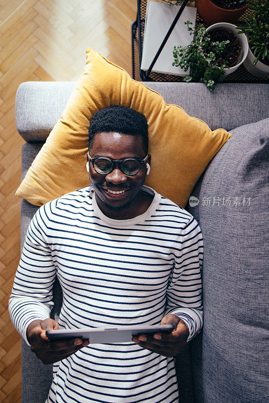 Top View Of Happy BusinessmanÂ Using A Digital Tablet In The Living Room